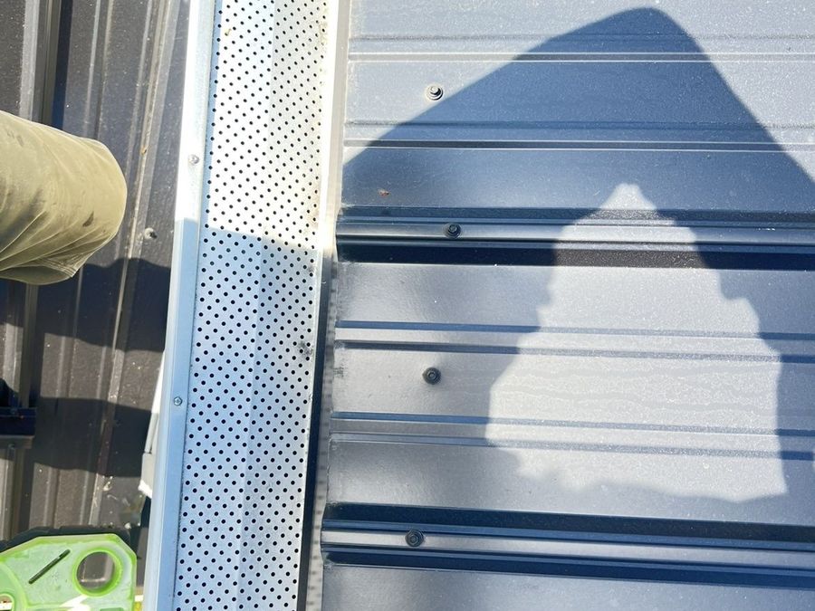 Clear, flushed eavestrough with guards refitted after cleaning